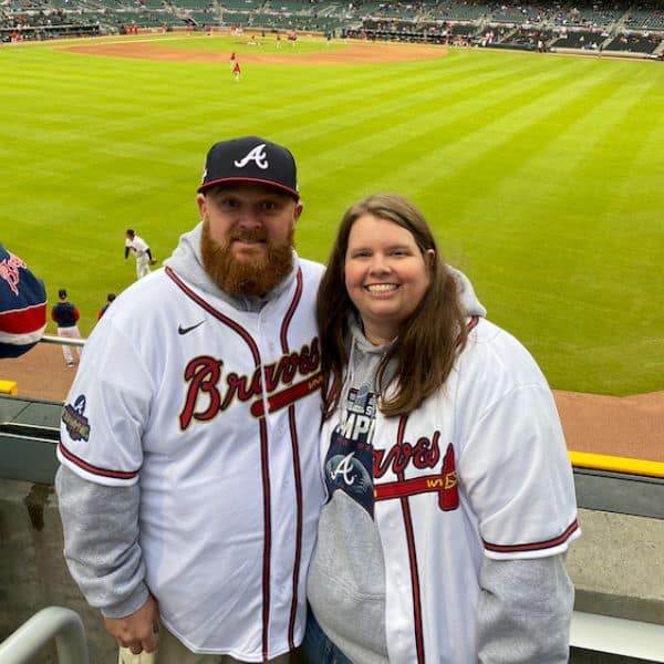 Allison Sammons and her husband David at Truist Park in Atlanta, wearing Atlanta Braves jerseys