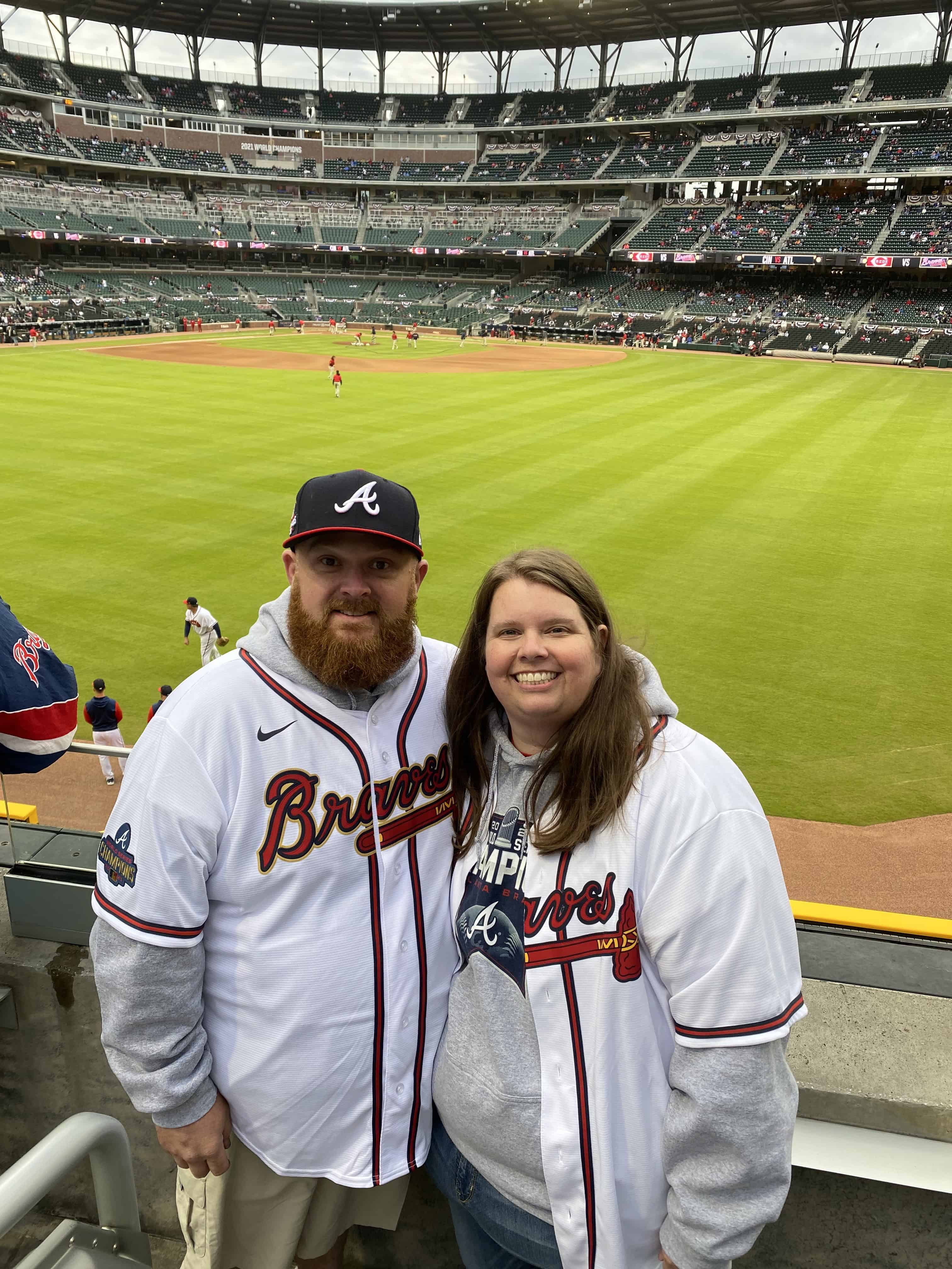 Allison Sammons and her husband David at Truist Park in Atlanta, wearing Atlanta Braves jerseys